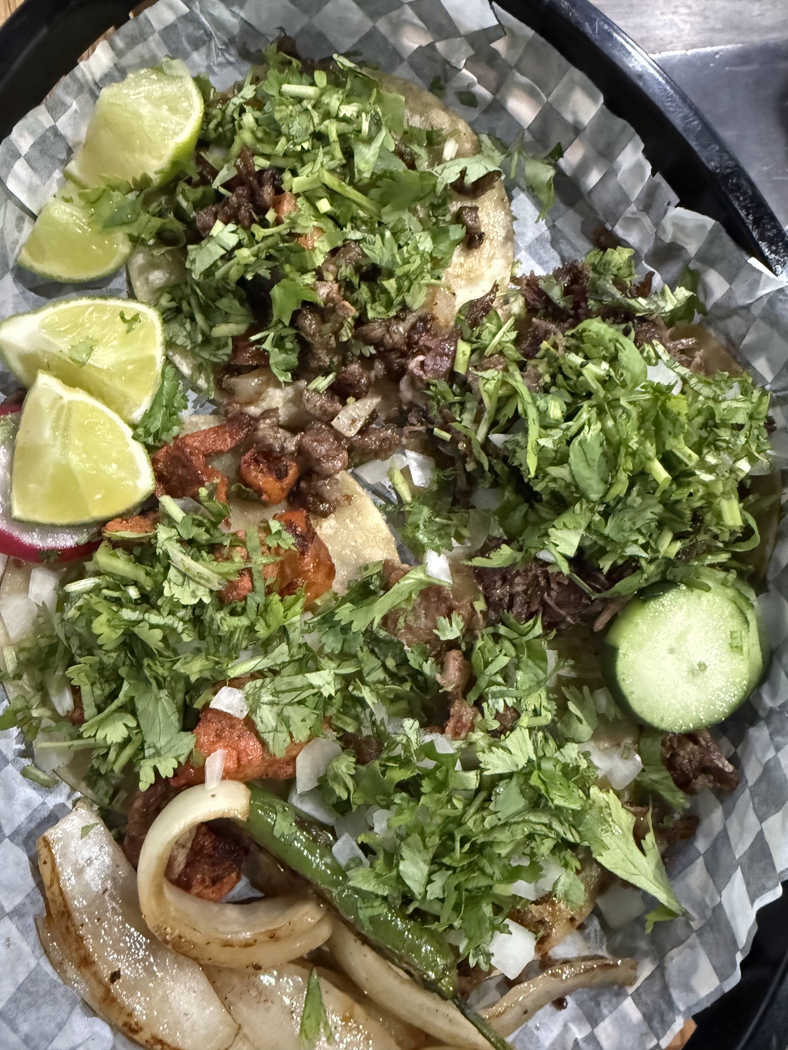 Street tacos topped with cilantro, onion and lime