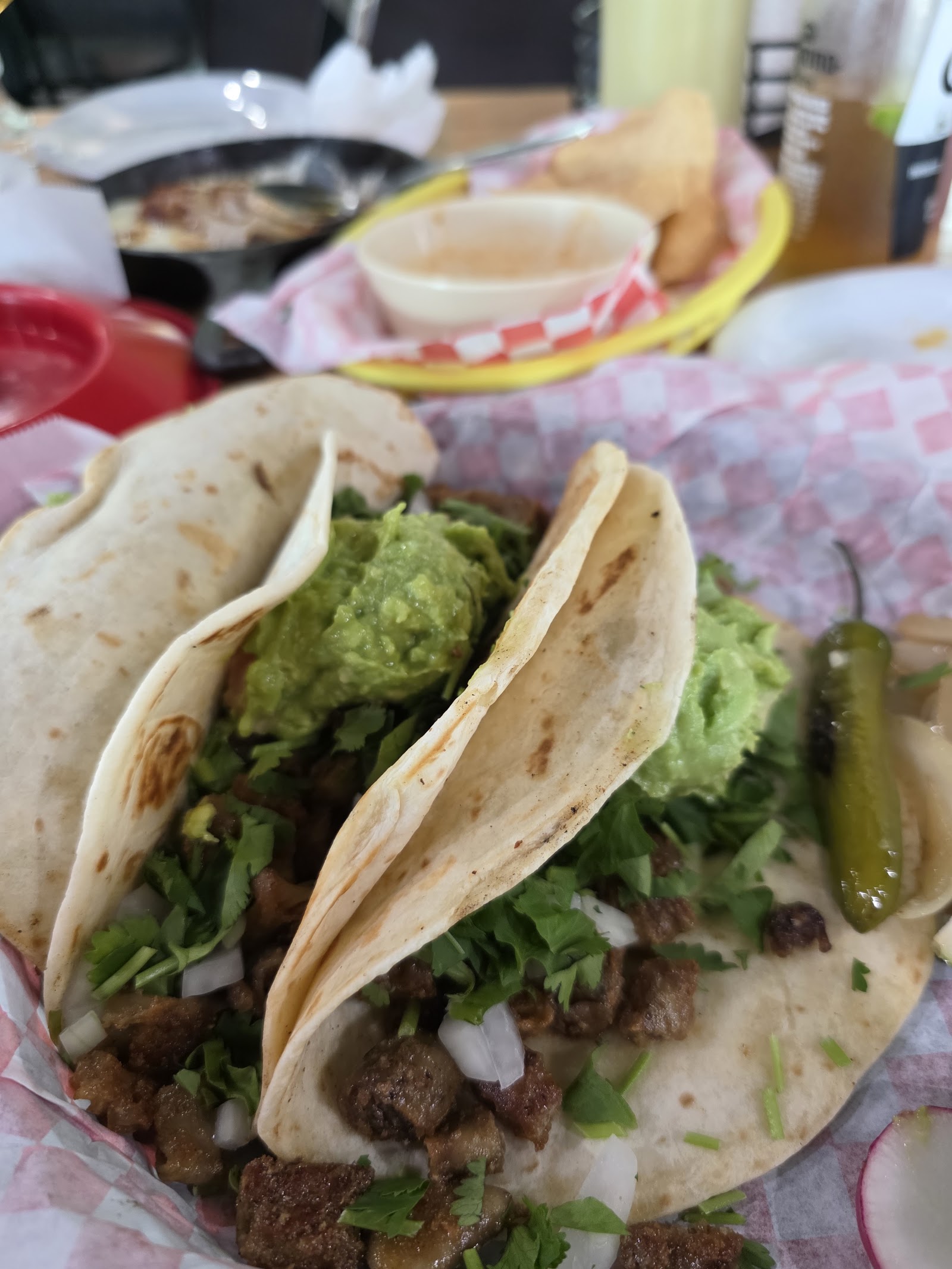 Birria tacos with a cup of dipping consom&eacute;